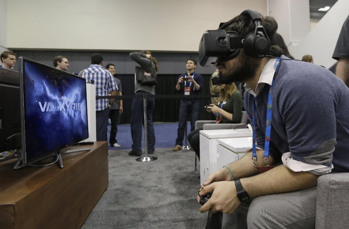 Facebook shares fell nearly 7% Wednesday on the news that the giant social network is paying $2 billion-plus for Oculus. Above, a man tries the Oculus virtual reality headset at the Game Developers Conference in San Francisco this month.