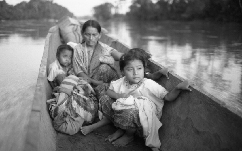 "Refugee woman and three children in a canoe, Chiapas," 1983, by Richard Cross, on view at L.A.'s Museum of Social Justice.