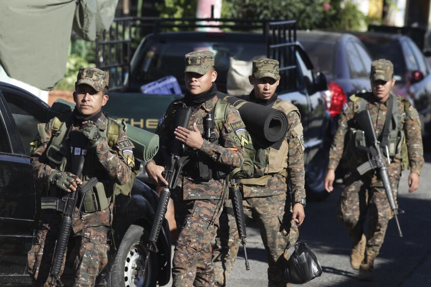 Soldiers arrive in Soyapango, El Salvador, Saturday, Dec. 3, 2022. The government of El Salvador sent 10,000 soldiers and police to seal off Soyapango, on the outskirts of the nation’s capital Saturday to search for gang members. (AP Photo/Salvador Melendez)