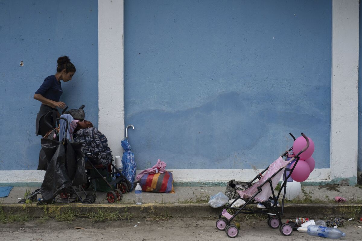 A migrant rests in Ulapa, Chiapas state, Mexico, Saturday, Oct. 30, 2021. The migrant caravan heading north in southern Mexico has so far been allowed to walk unimpeded, a change from the Mexican government’s reaction to other attempted mass migrations. (AP Photo/Isabel Mateos)