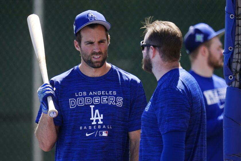 Los Angeles Dodgers' Chris Taylor, left, talks with Max Muncy as they take batting practice.