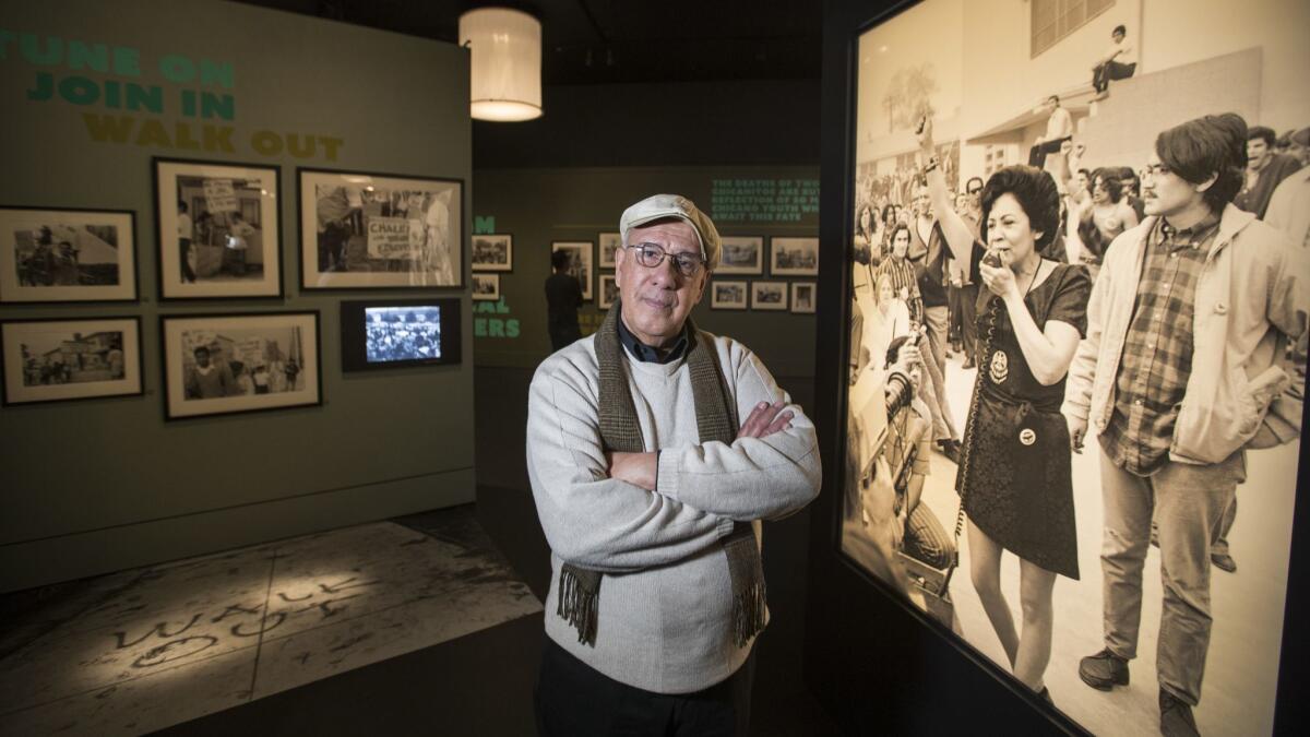 Photographer Luis Garza stands amid the exhibition he helped curate. "La Raza" features images from the activist newspaper.