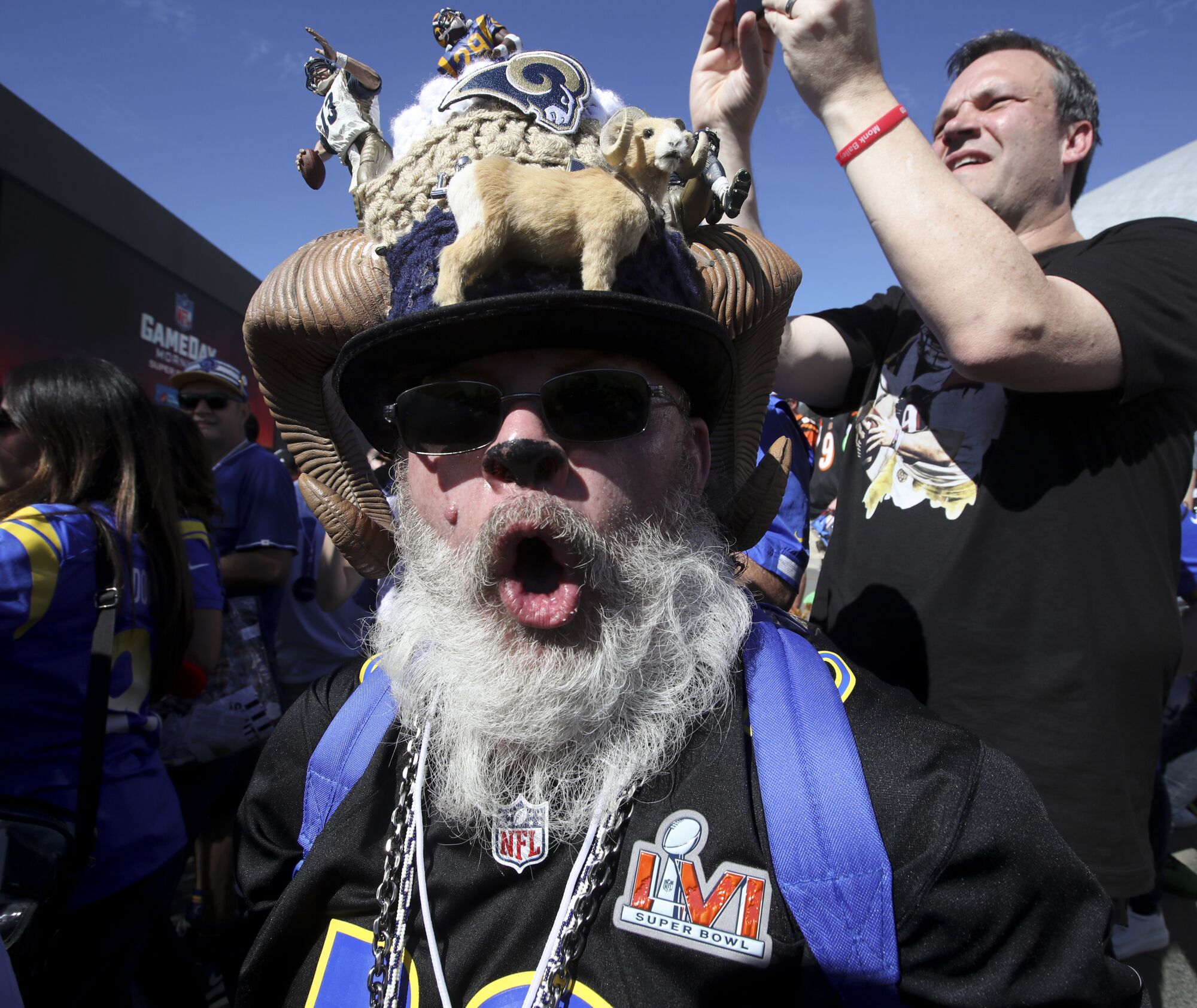 A Rams fan in a hat with a Rams model on it outside SoFi Stadium