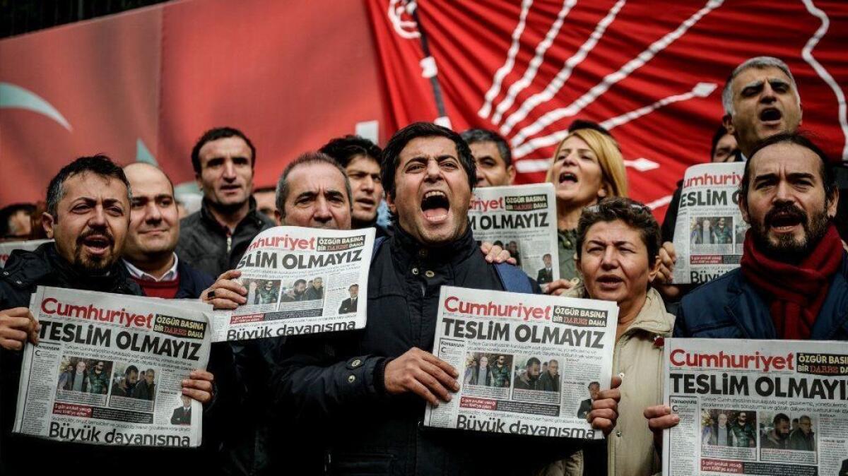 Protesters hold copies of the Turkish daily Cumhuriyet during a demonstration outside the newspaper's Istanbul offices in November 2016.