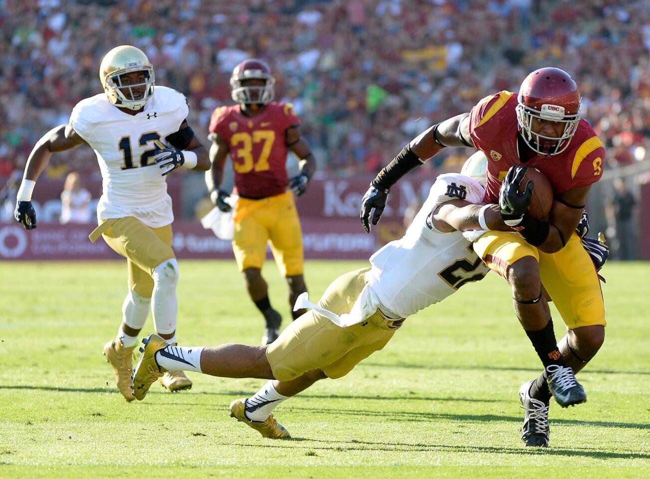 USC's JuJu Smith runs after his catch as he is tackled by Notre Dame's Elijah Shumate during the third quarter.