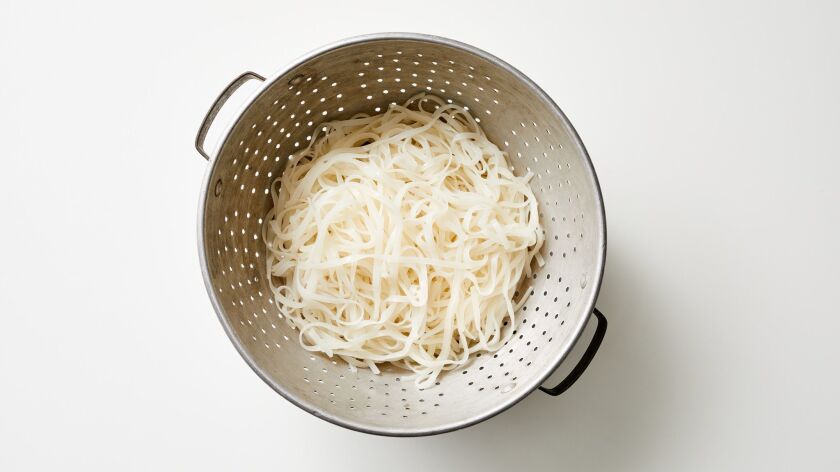 Rice noodles in a colander
