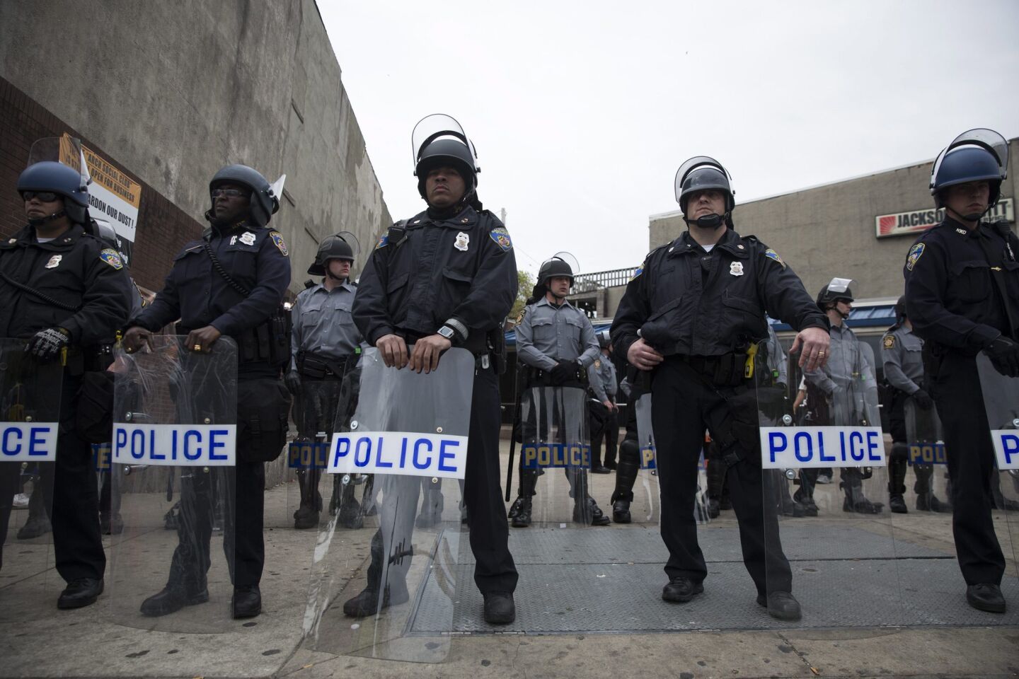 Police and National Guard mobilize in riot gear at Pennsylvania Avenue and West North Avenue in Baltimore.