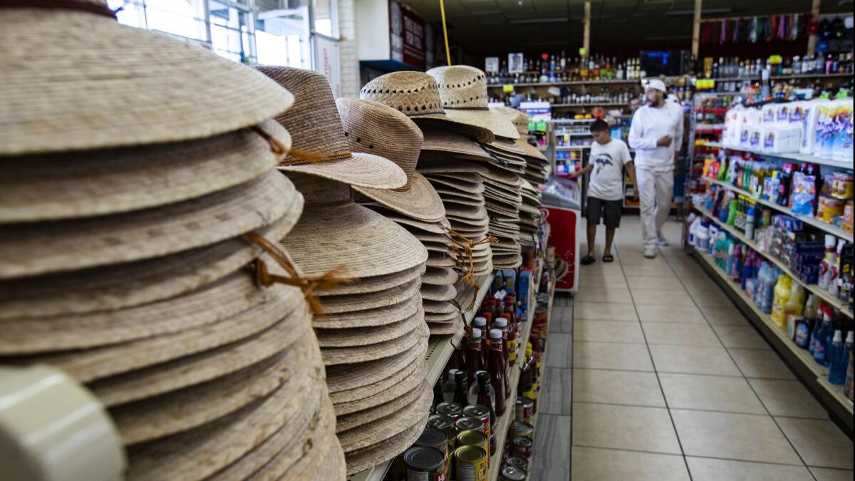 The shelves are stocked with straw hats for customers attending Coachella.