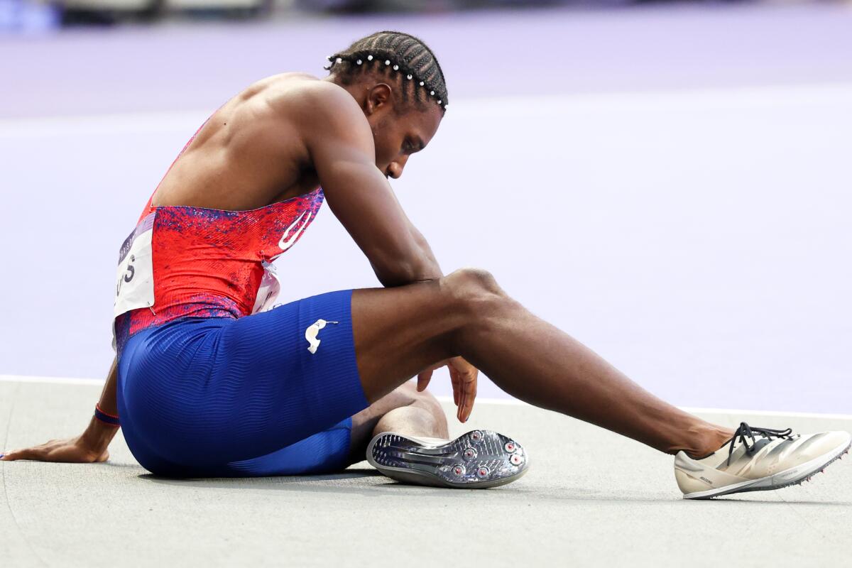 American Noah Lyles sits on the track after winning the bronze medal during the men's 200-meter final