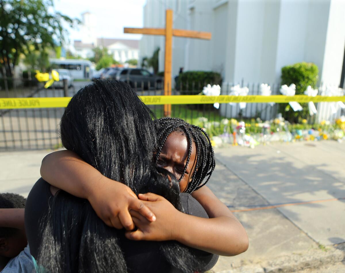 Kearston Farr hugs her daughter Taliyah, 5, at a memorial in front of the Emanuel AME Church in Charleston, S.C., on Friday.