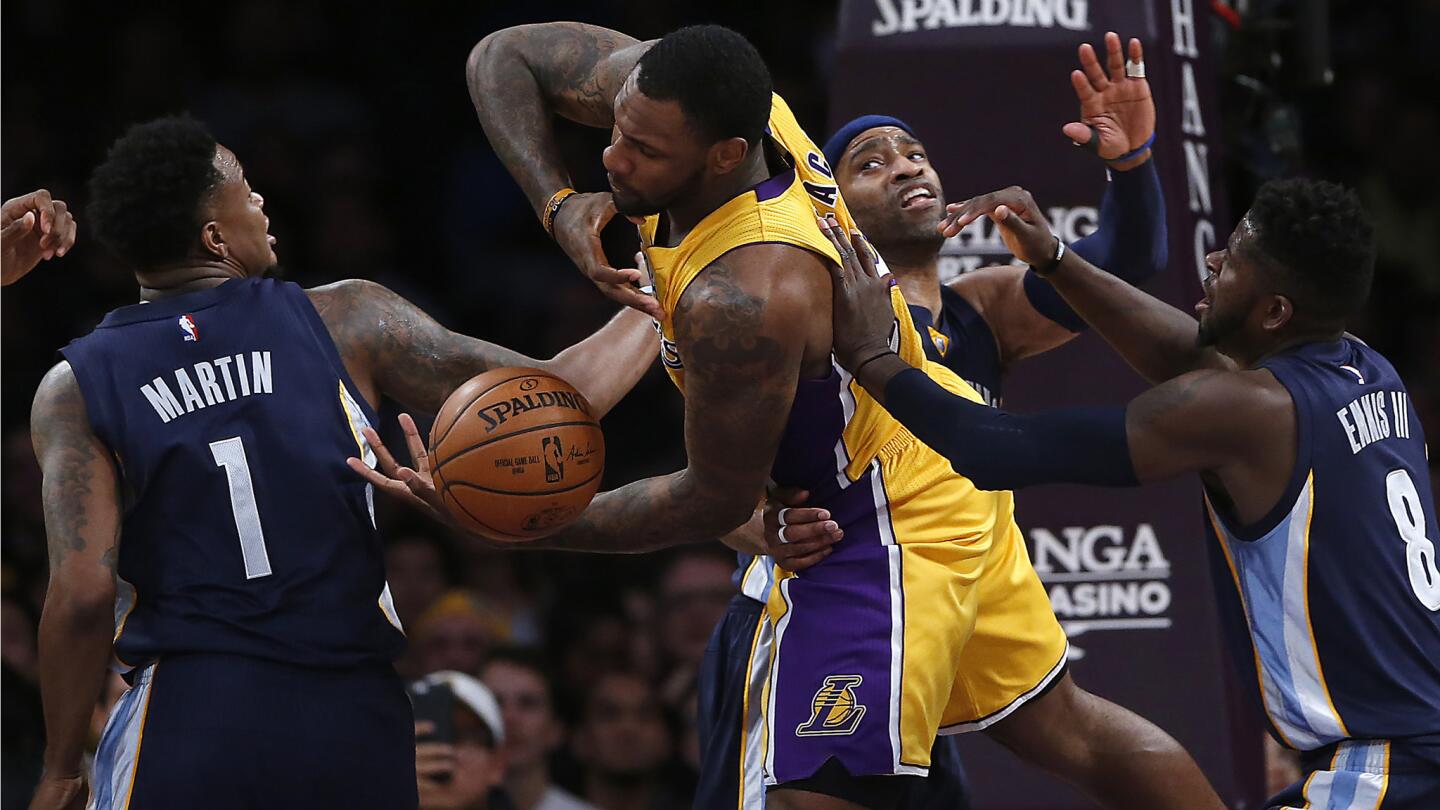 Lakers center Tarik Black can't control a rebound as he battles Memphis Grizzlies players (from left) Jarell Martin, left, Vince Carter and James Ennis, during second half action.