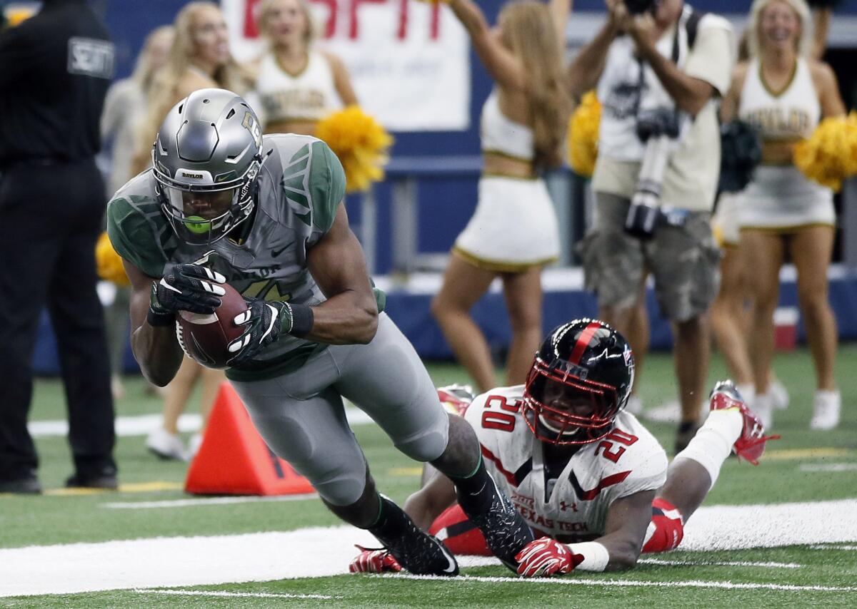 Baylor wide receiver Jay Lee dives forward for extra yardage after being caught from behind on a pass play by Baylor's Aiavion Edwards.