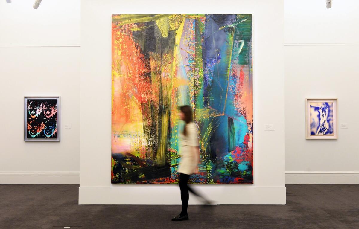 A Sotheby's staff member walks past Gerhard Richter's "Abstraktes Bild," which sold for more than $46 million this week after going for just $607,500 in a 1999 auction.