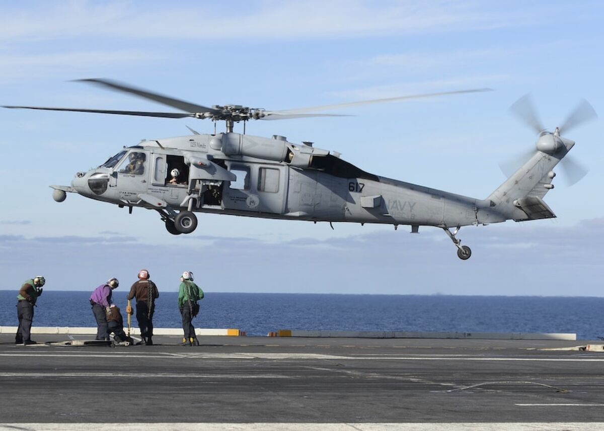 In this March 19, 2017, photo released by the U.S. Navy, an MH-60S Sea Hawk helicopter prepares to land on the flight deck of the aircraft carrier USS Nimitz in the Pacific Ocean. The Navy declared five missing sailors dead Saturday, Sept. 4, 2021, nearly a week after their helicopter, similar to the one pictured, crashed in the ocean off San Diego. (Mass Communication Specialist Seaman Ian Kinkead/U.S. Navy via AP)