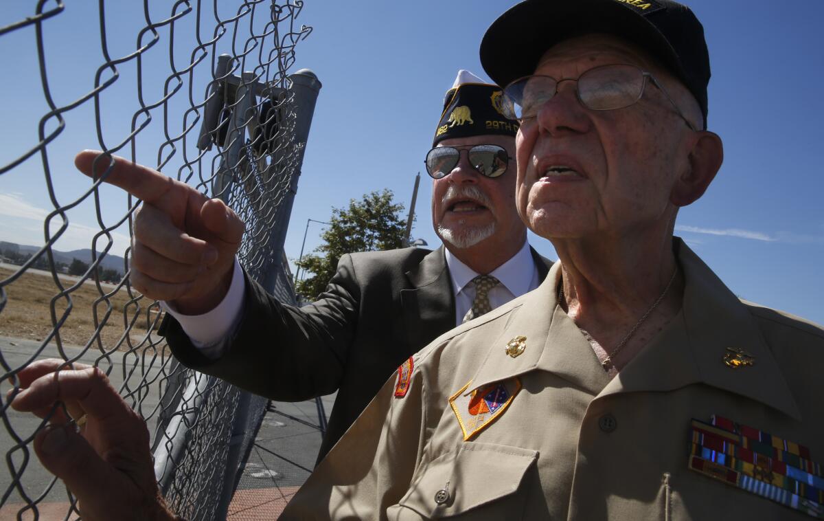 Former Marine Sgt. Bill Cook, left, chairman of the Orange County Veterans Memorial Park Committee, talks with former Marine Maj. Neil Reich at the Great Park.