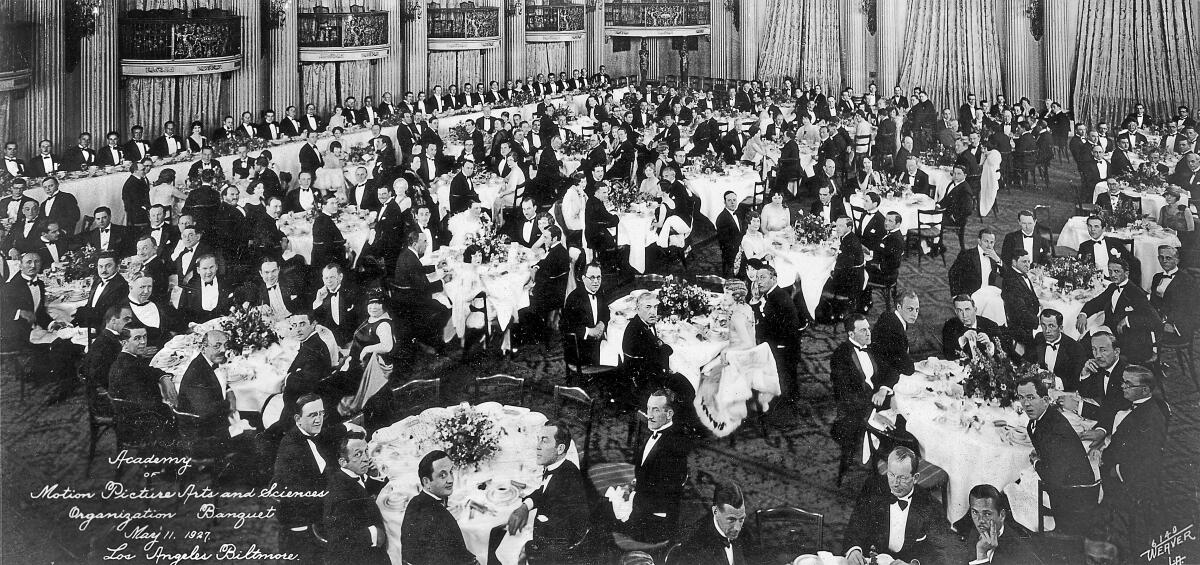 People sit at tables in a large dining area.