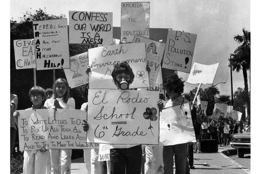 Sixth-grader Brad Frank, 11, wearing a gas mask, joins about 100 classmates during an Earth Day march on Wilshire Boulevard on the first Earth Day, April 22, 1970.