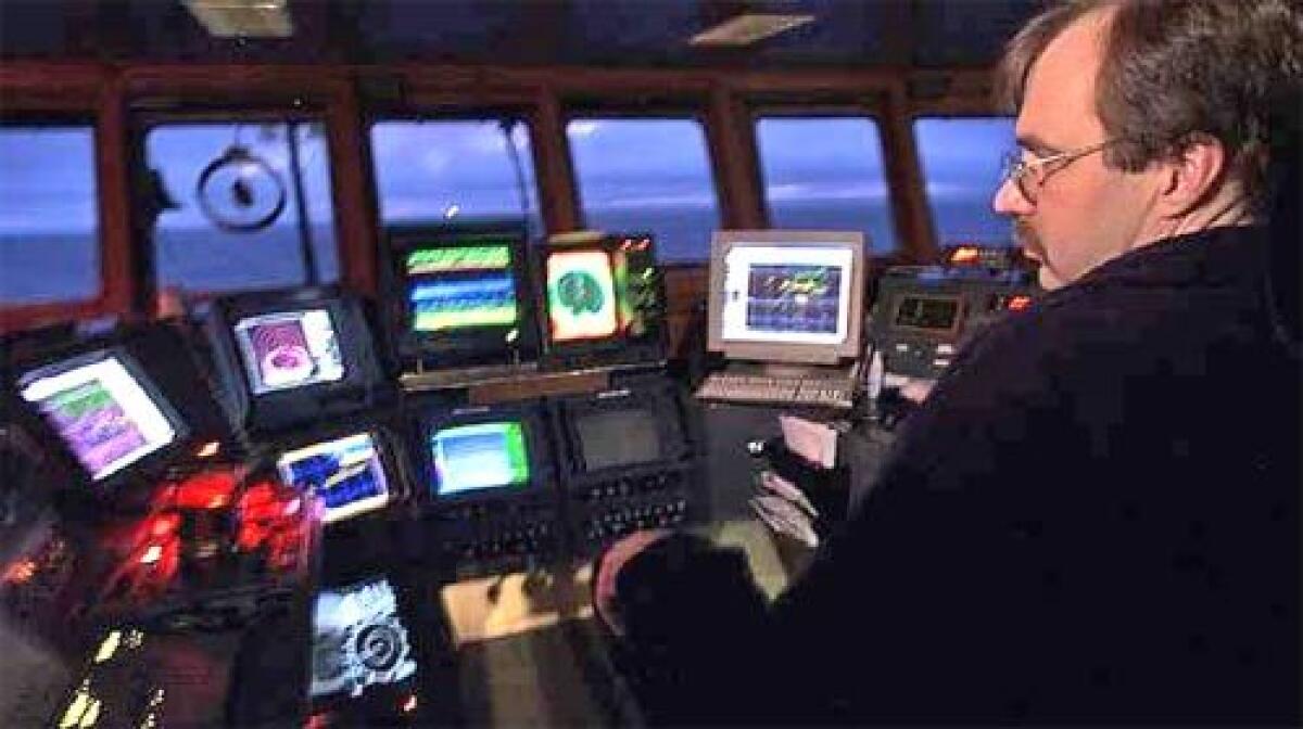 In the dark of night, Brooks Stephens of the Northern Eagle monitors the screens as computers scan the waters for schools of pollock.