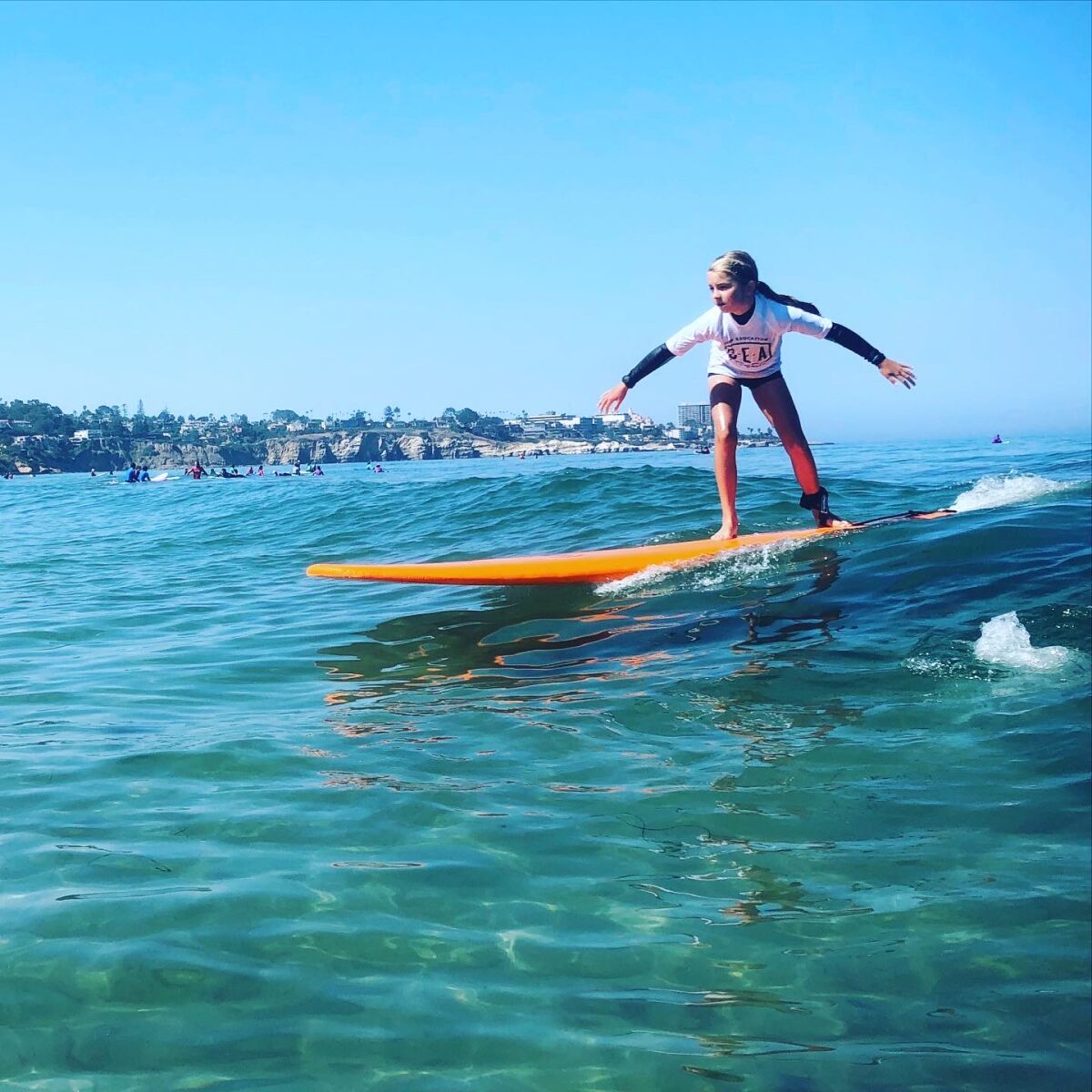 A student at the La Jolla Shores-based Surf Education Academy takes to the water.