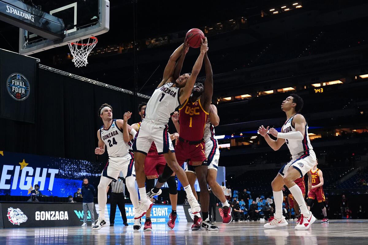 Gonzaga's Jalen Suggs and USC's Chevez Goodwin compete for the ball.