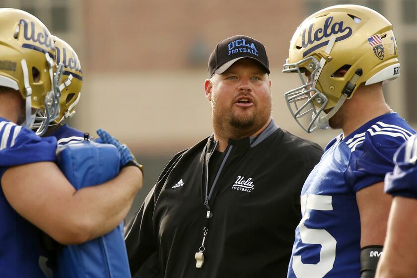 LOS ANGELES, CA - APRIL 6, 2017- UCLA football Hank Fraley works with offensive line during spring practice on the campus April 6, 2017. The Bruins have four new coaches. (Al Seib / Los Angeles Times)