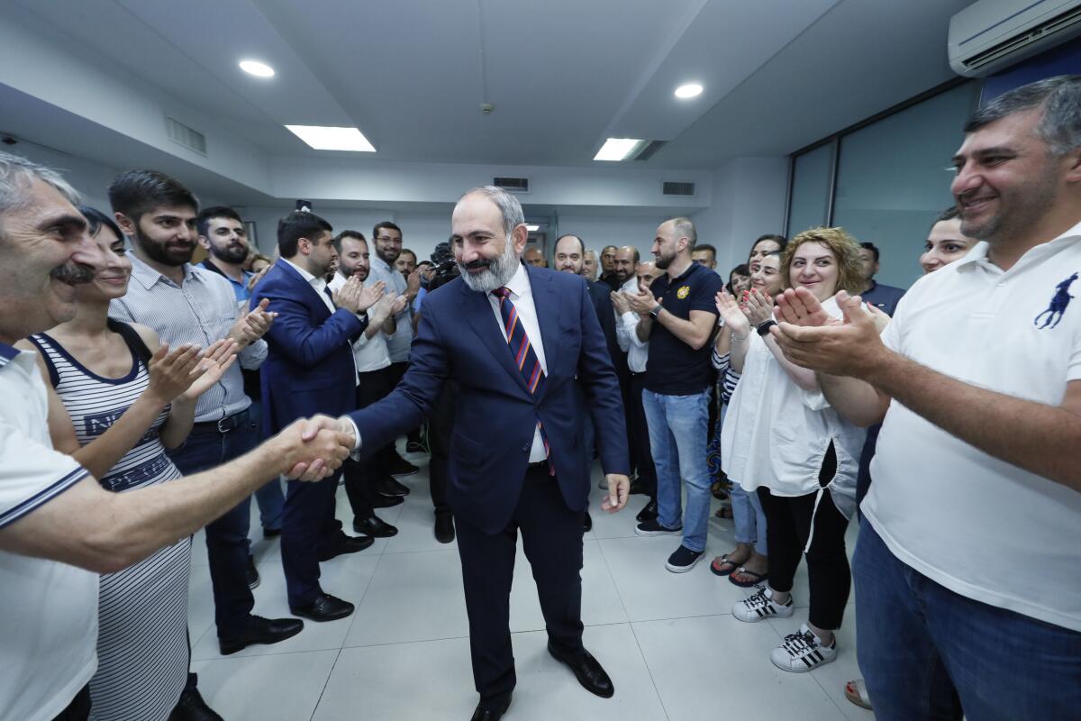 Armenian acting Prime Minister Nikol Pashinyan shaking hands