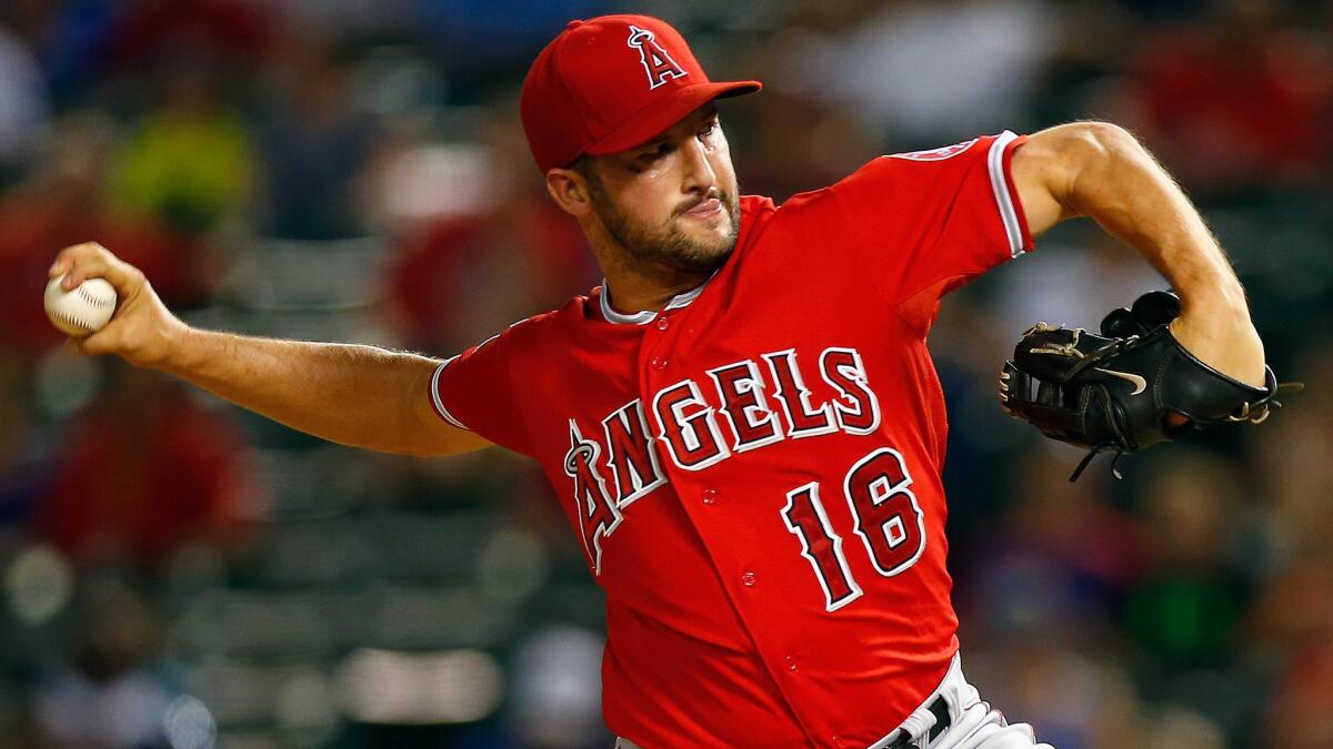 Angels closer Huston Street delivers a pitch against the Texas Rangers on Aug. 15. The Angels' acquisition of Street has made the team more confident in its bullpen.