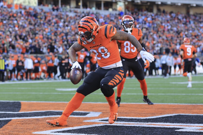 Cincinnati Bengals running back Joe Mixon (28) celebrates after scoring a touchdown against the Pittsburgh Steelers during the first half of an NFL football game, Sunday, Nov. 28, 2021, in Cincinnati. (AP Photo/Aaron Doster)