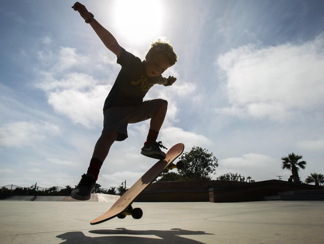 Eight-year-old Ryan Scully rides his skateboard while wearing a wrist device and heart rate monitor on his chest, to record heart rate, how far he's skated, and length of time skating.