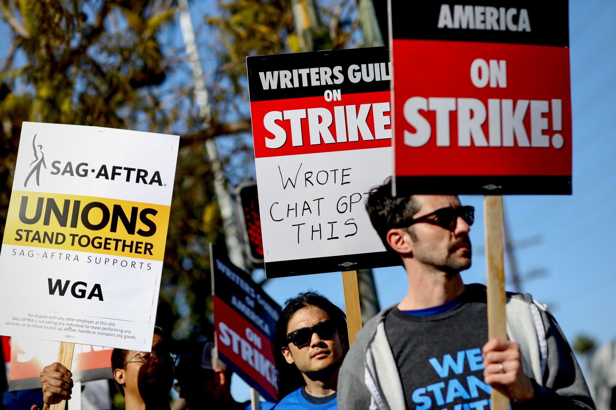 Writers Guild of America members walk the picket line on the first day of their strike in front of Sony Pictures 