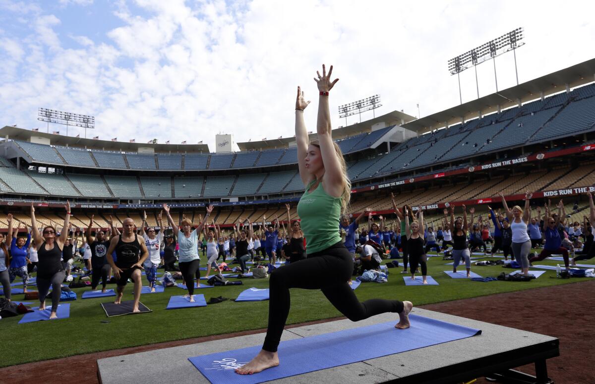 Chara Law helps lead a YogaWorks class after a Dodgers game last month.