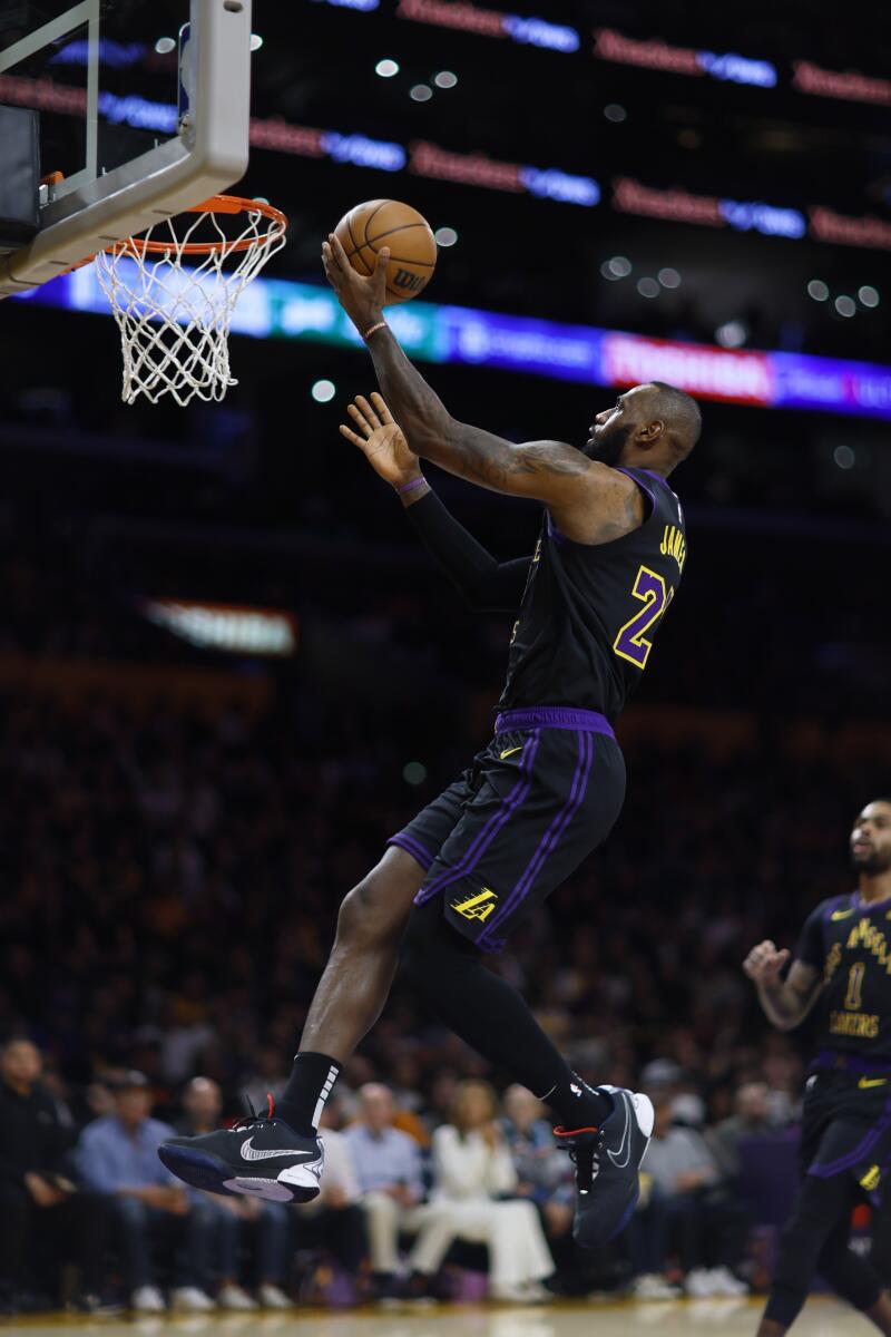 Lakers star LeBron James scores during the first quarter against the Knicks.