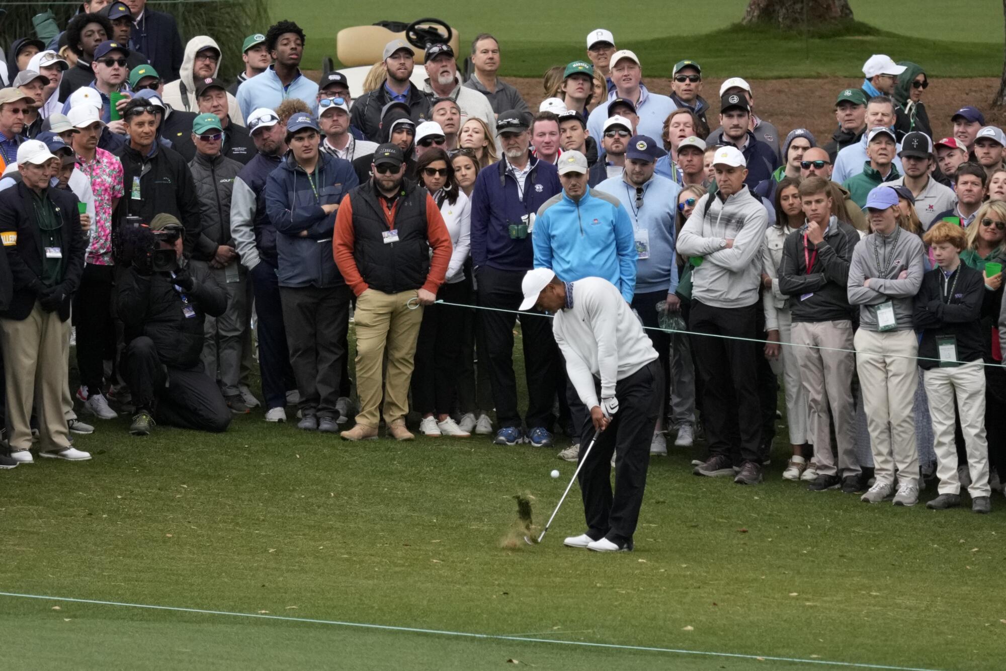 Tiger Woods hits from the rough on the third hole during the third round.