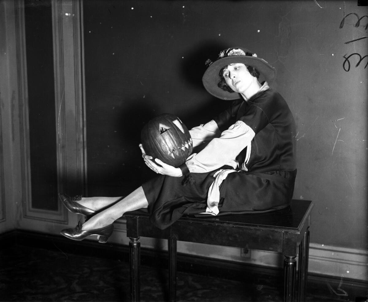 Miss Jerry Long poses with a jack-o'-lantern in October 1925.
