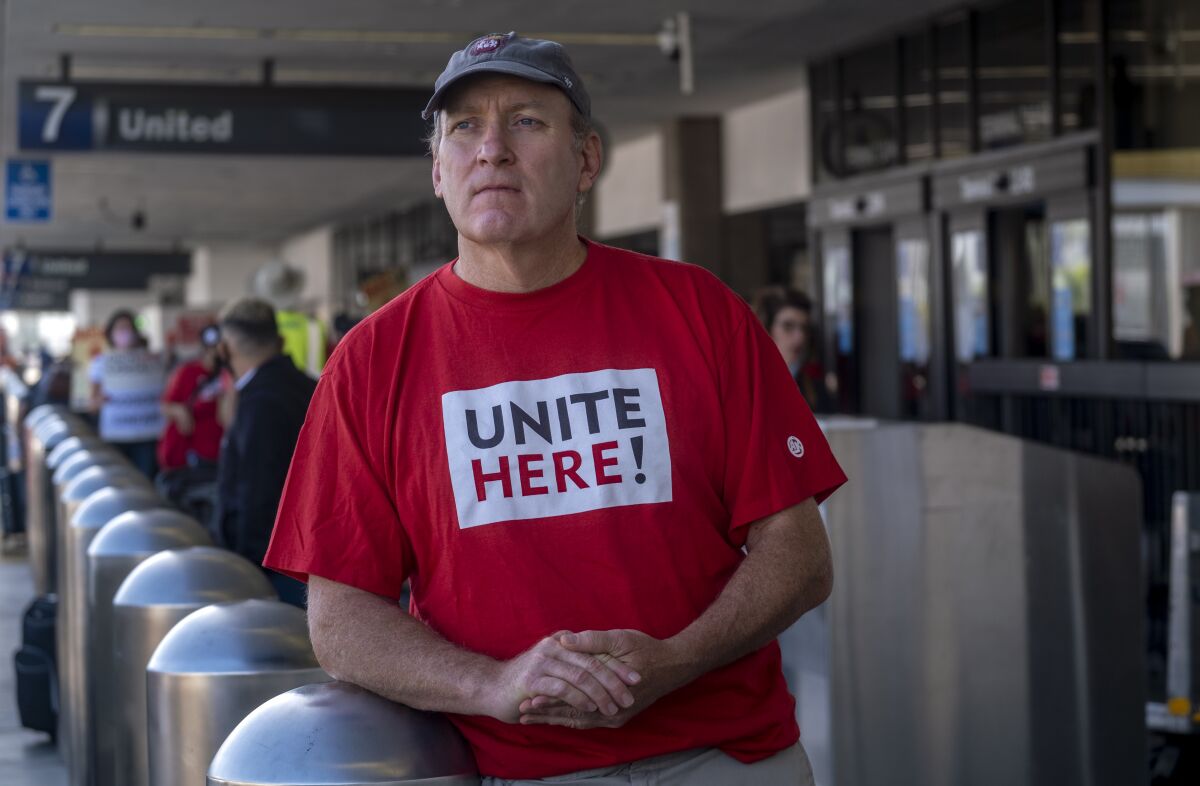 A man wears a T-shirt that reads "Unite Here!"  