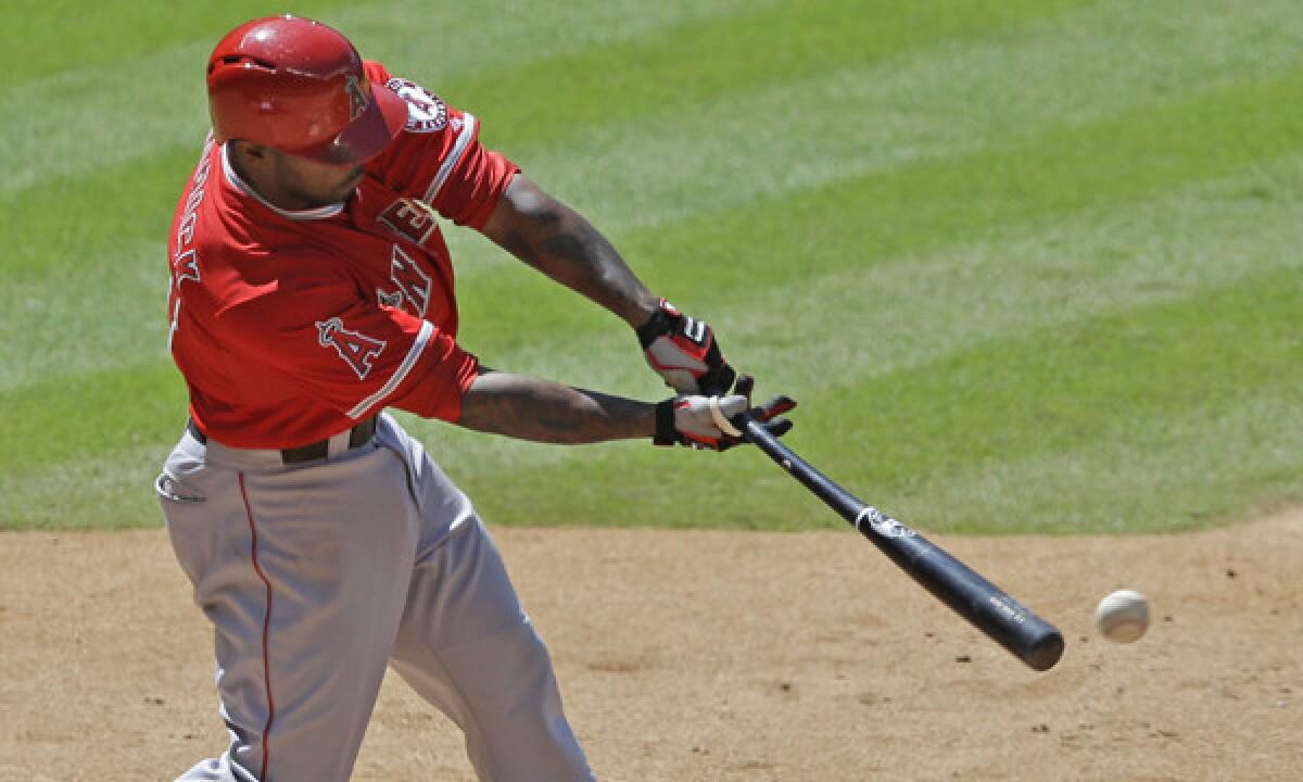 Angels second baseman Howie Kendrick hits a run-scoring single in a win over the Houston Astros on Monday.