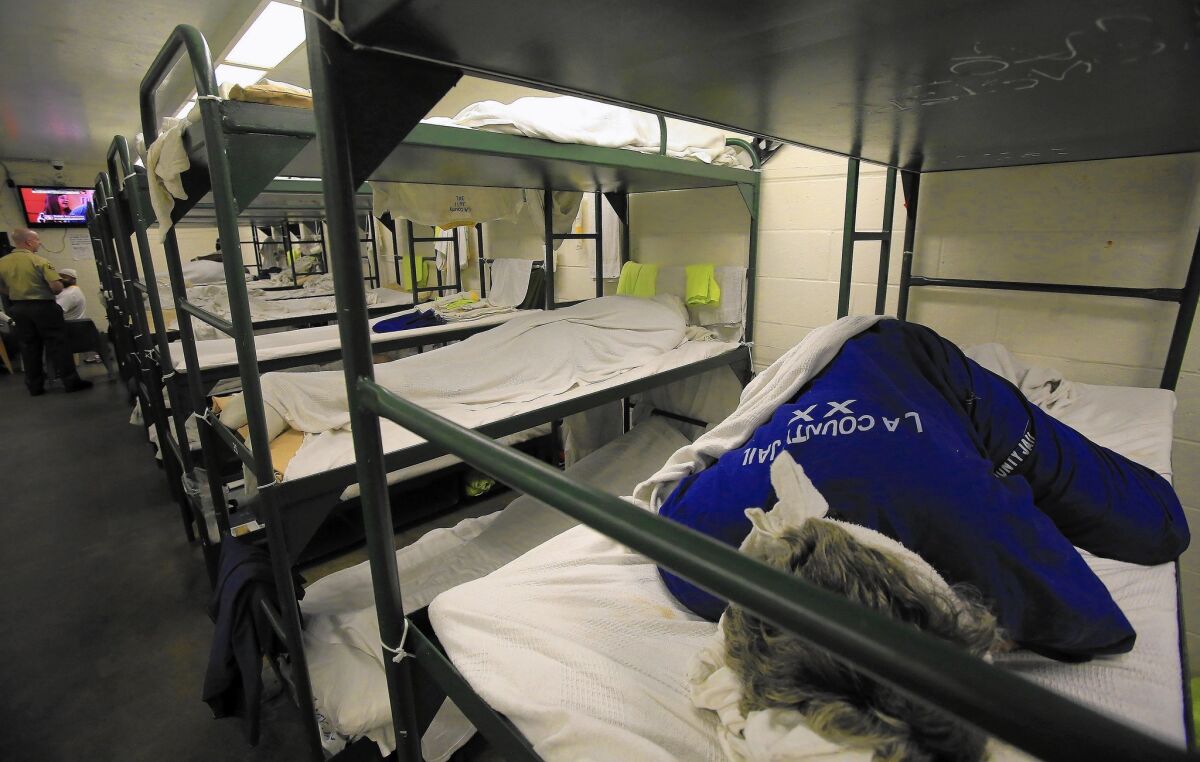 An inmate sleeps in a triple bunk dorm room in the Men's Central Jail. Proposition 47 has reduced jail crowding, curtailing the need for early release programs.
