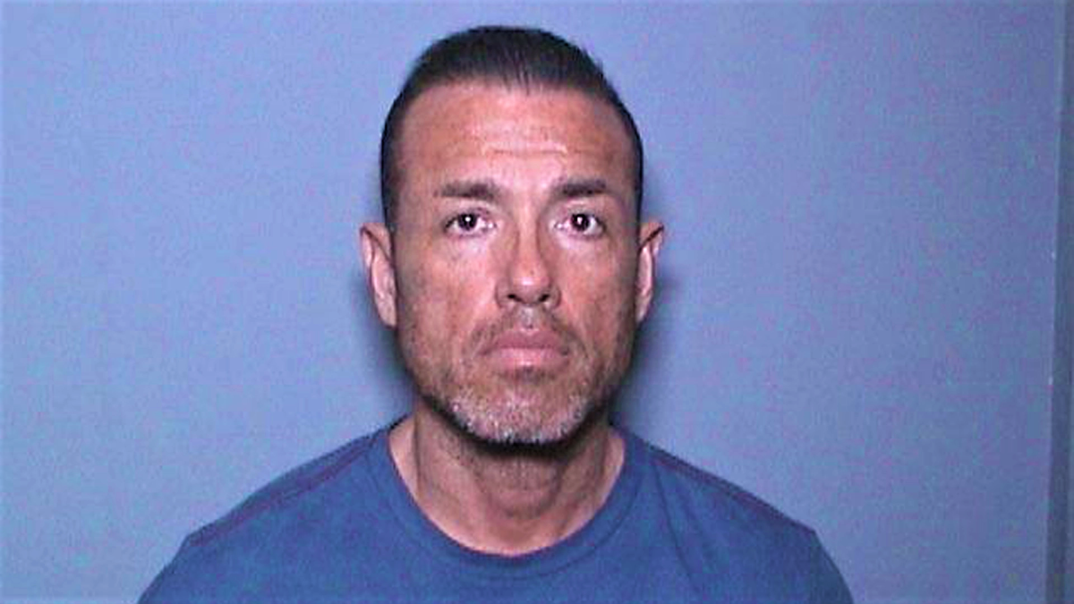 Former basketball coach Carlos Francisco Juarez, seen in a 2019 booking photo.