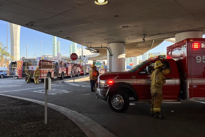 Los Angeles, CA - October 31: First responders investigate the scene where a carbon dioxide leak left four people sick at Los Angeles International Airport on Monday, Oct. 31, 2022 in Los Angeles, CA. (Carolyn Cole / Los Angeles Times)