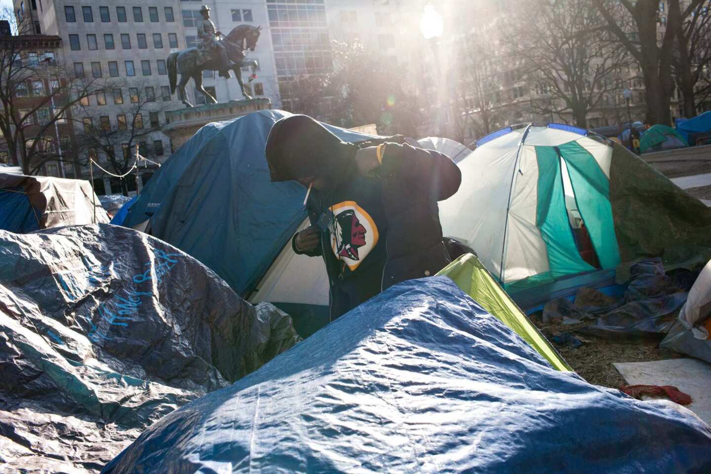 Craig Gill gets dressed outside his tent in the Occupy D.C. encampment in McPherson Square.