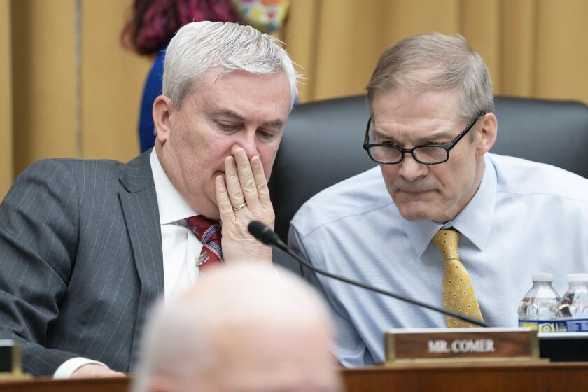 House Oversight and Accountability Committee Chair Rep. James Comer, R-Ky., left, and House Judiciary Committee Chair Rep. Jim Jordan, R-Ohio, talk while listening to testimony from Special Counsel Robert Hur during a hearing of the House Judiciary Committee in the Rayburn Office Building on Capitol Hill in Washington, Tuesday, March 12, 2024. (AP Photo/Nathan Howard)