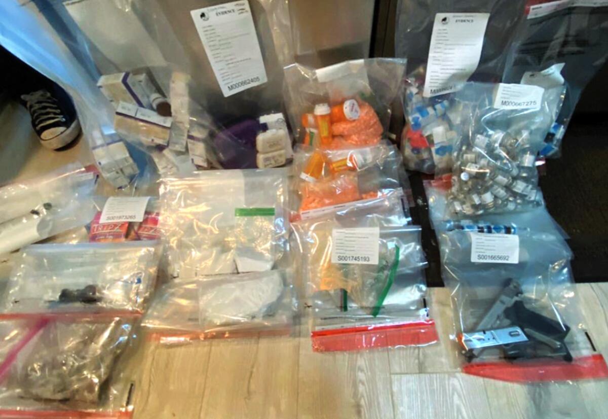 Narcotics in baggies displayed on a table.