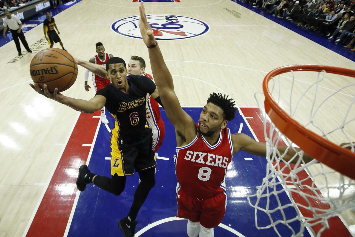 Lakers guard Jordan Clarkson (6) tries to get a shot past 76ers center Jahlil Okafor (8) during the second half on Dec. 16.