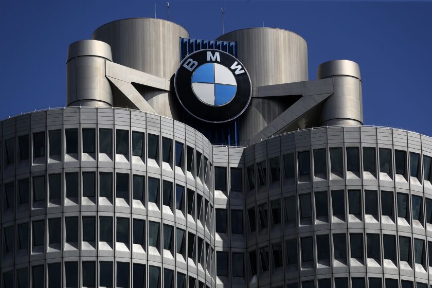 FILE - The logo of German car manufacturer BMW is fixed at the headquarters in Munich, Germany, May 14, 2021. A German court has rejected a lawsuit by environmental campaigners seeking to force automaker BMW to stop selling combustion engine vehicles by 2030. (AP Photo/Matthias Schrader, file)