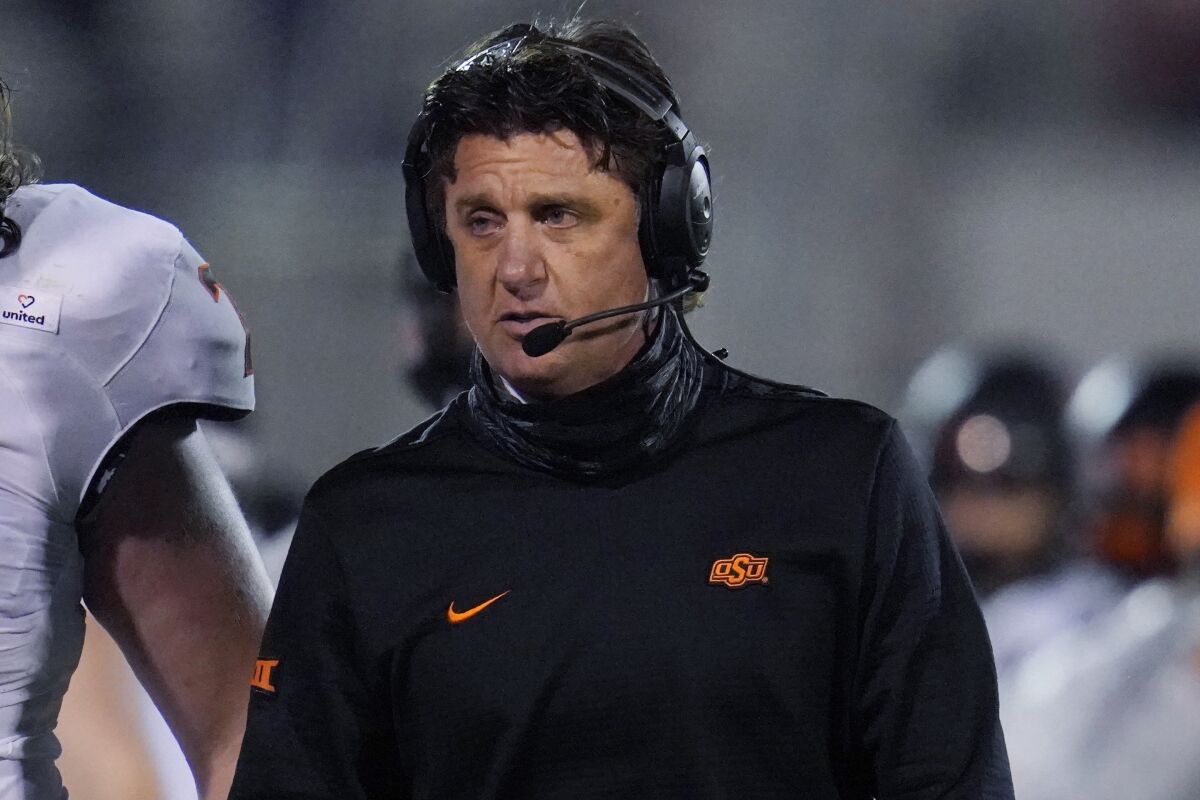 Oklahoma State coach Mike Gundy walks on the sideline during the second half of the team's NCAA college football game against Oklahoma in Norman, Okla., Saturday, Nov. 21, 2020. (AP Photo/Sue Ogrocki)