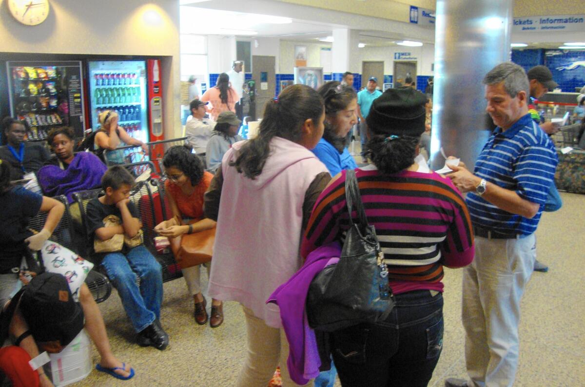 Central American immigrants arrive at a San Antonio bus station, where many depart for their U.S. destinations. A federal program issues smartphones to many such immigrants to assist them on their journey.