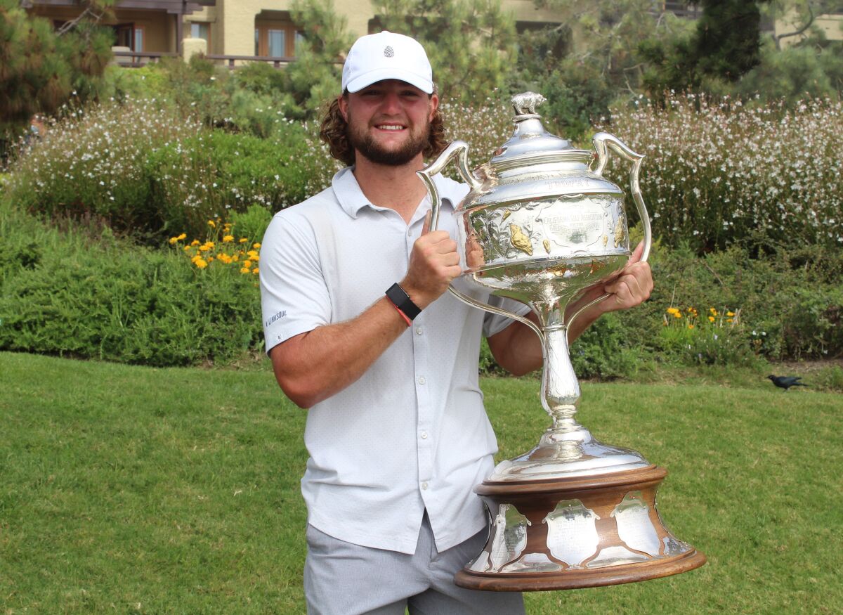 Pepperdine golfer Joey Vrzich proudly shows off his trophy for winning the California Amateur.
