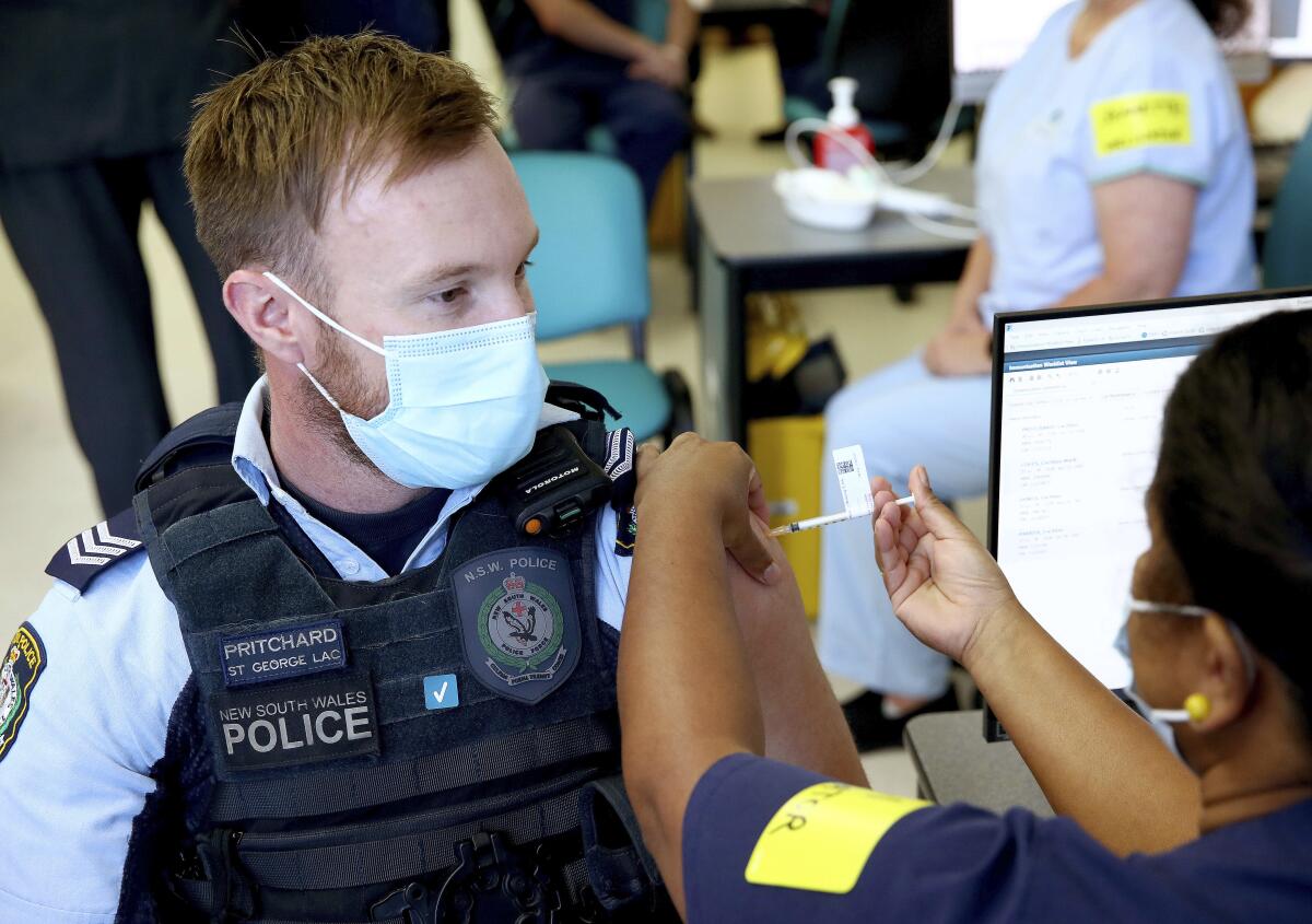 Police officer receives COVID-19 shot in Sydney, Australia