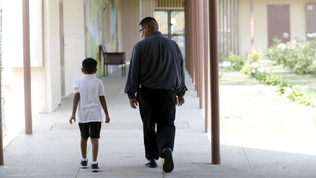 Principal Jose Razo, right, counsels a frustrated student at Telfair Elementary School.