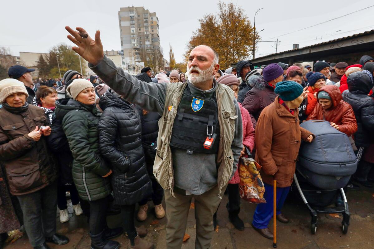 José Andrés stands amid people lining up for food in Kherson, Ukraine.